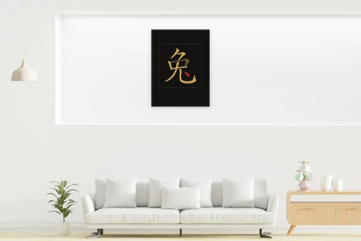 Signe du Lapin en aplats, encre d’or. Photo d'illustration : Affiche encadrée noir dans la niche éclairée d'un salon blanc, œuvre en 60 × 80 cm, à l'échelle. Photo de la pièce : dada design (Unsplash).